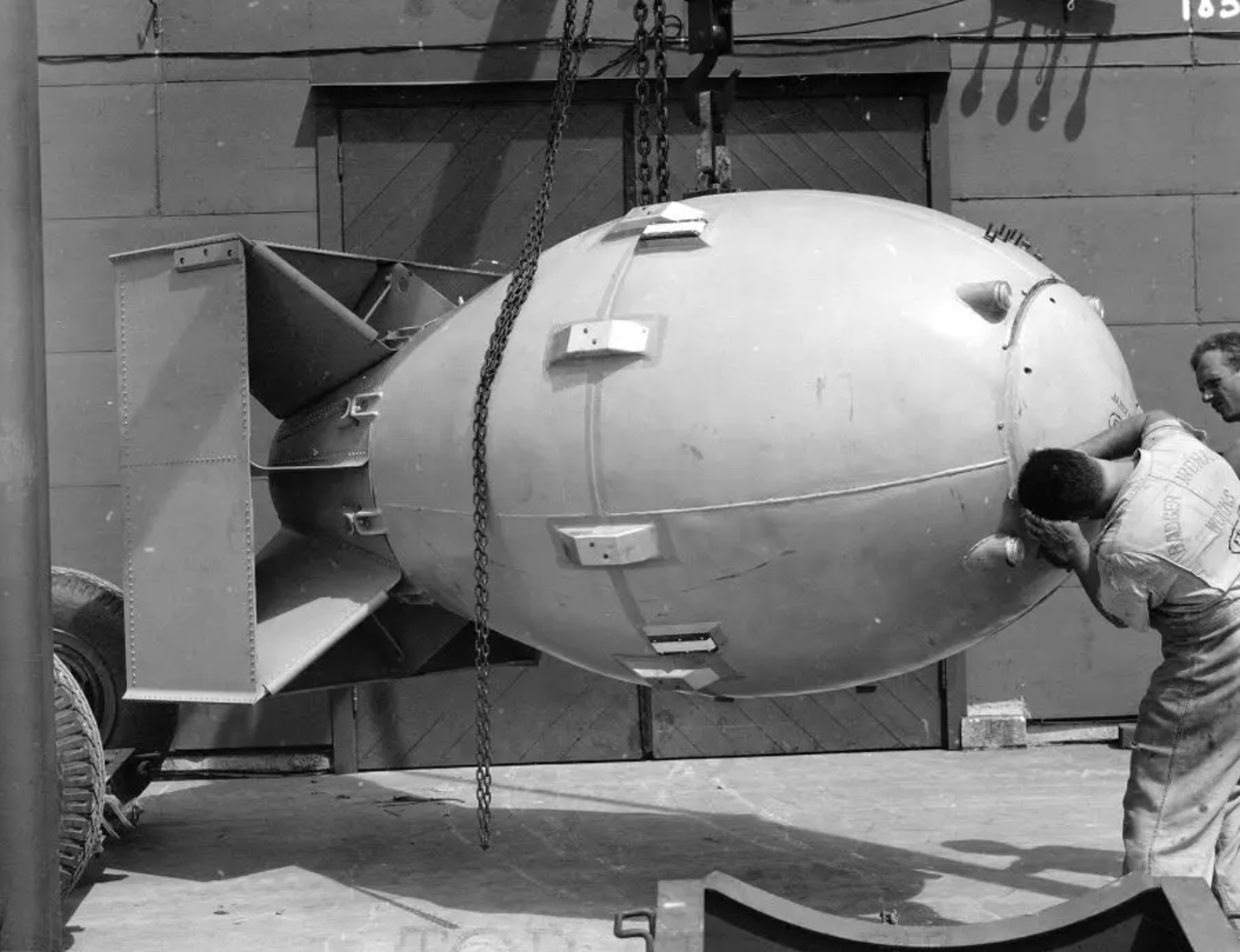 The 'Fat Man' bomb being inspected by a worker.